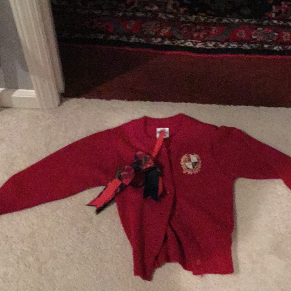 a uniform sweater with a bow